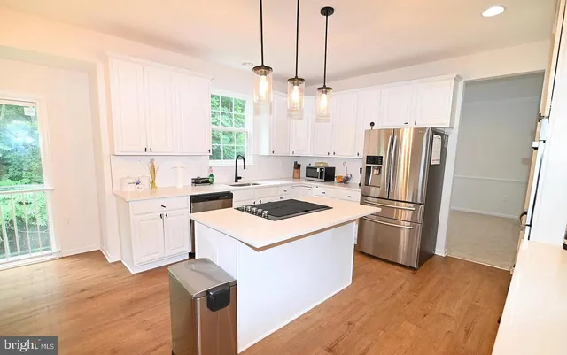 a kitchen with a sink a refrigerator a washer and dryer
