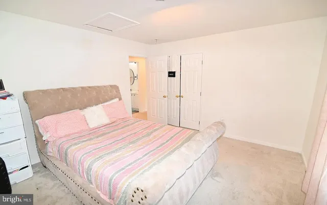 a bedroom with a bed and a painting