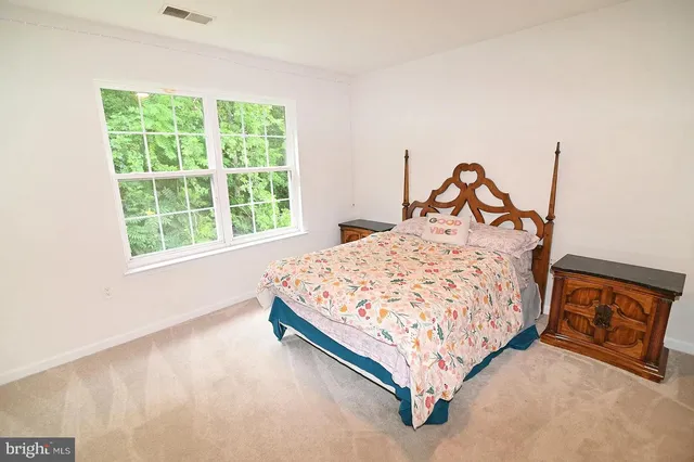 a bed sitting in a bedroom next to a window