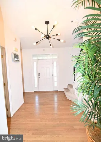 a view of a room with wooden floor and entryway