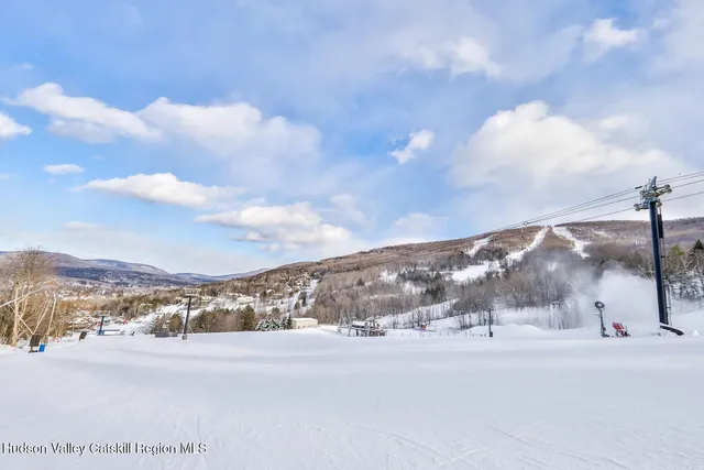 a dining room with furniture water view and wooden floor