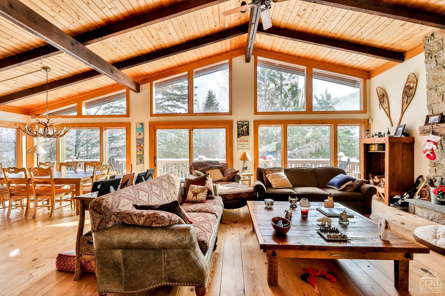 90 Club Road Windham, NY 12496 - Photo 21 of 77 a living room with furniture and floor to ceiling windows