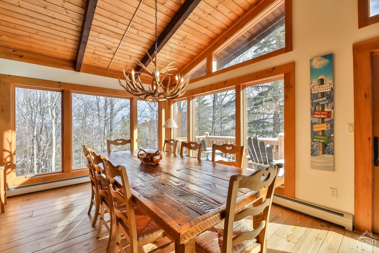 90 Club Road Windham, NY 12496 - Photo 28 of 77 a dining room with furniture water view and wooden floor
