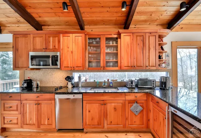 a bedroom with two beds and a lamp next to a window