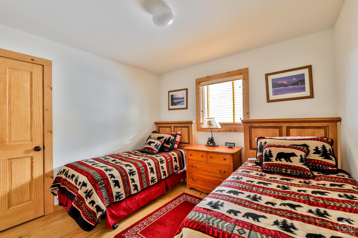 90 Club Road Windham, NY 12496 - Photo 54 of 77 a bedroom with two beds and a lamp next to a window