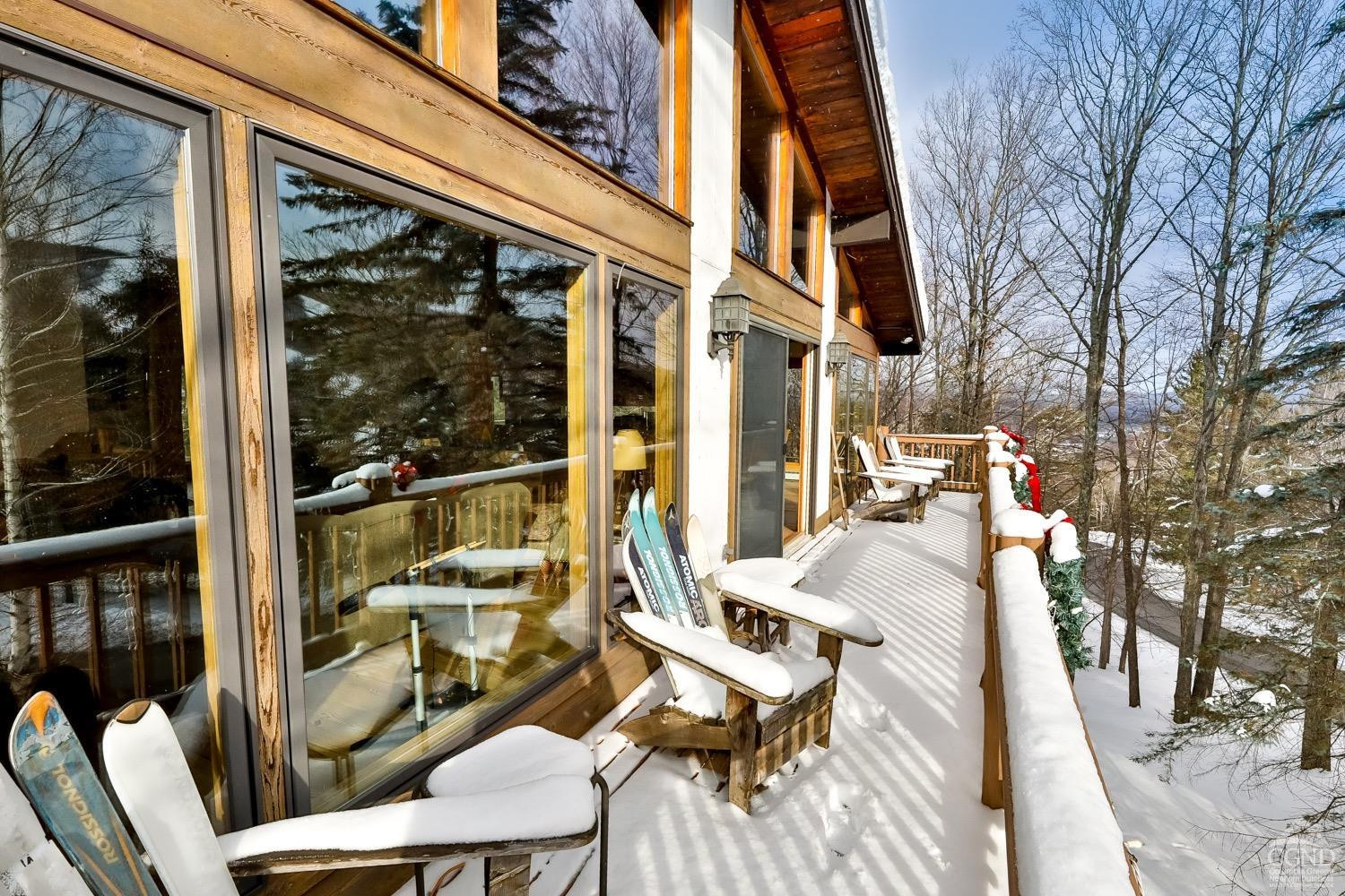 90 Club Road Windham, NY 12496 - Photo 67 of 77 a view of a patio with couches table and chairs and wooden floor