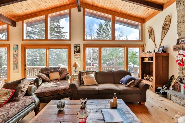 a living room filled with furniture and a large window