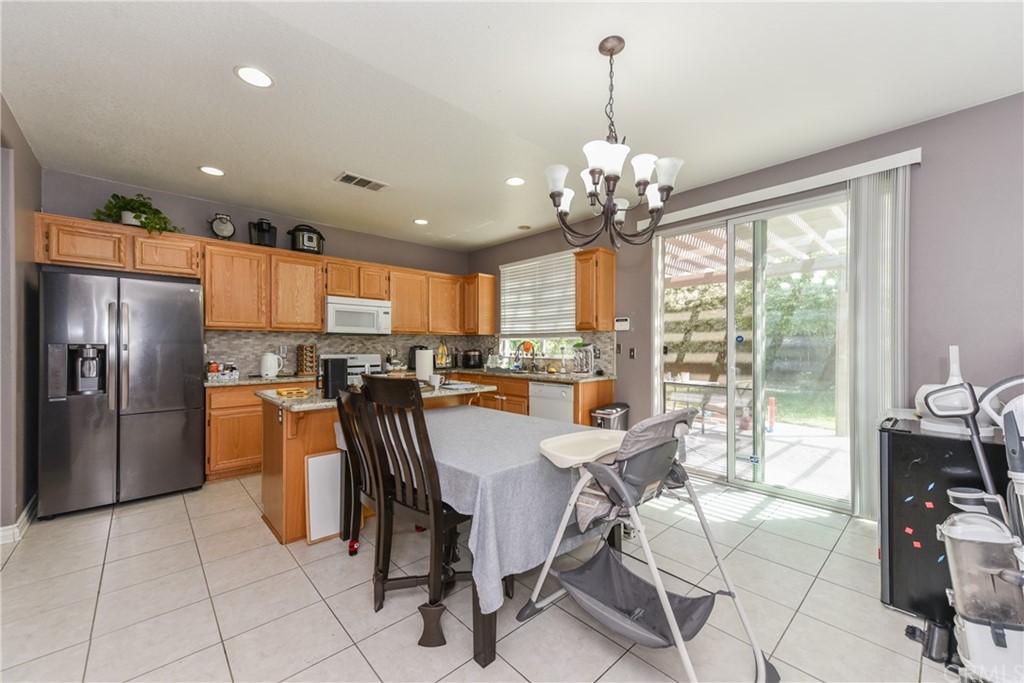 7637 Pinot Place Rancho Cucamonga, CA 91739 - Photo 11 of 39 a dining room filled counter top space and stainless steel appliances