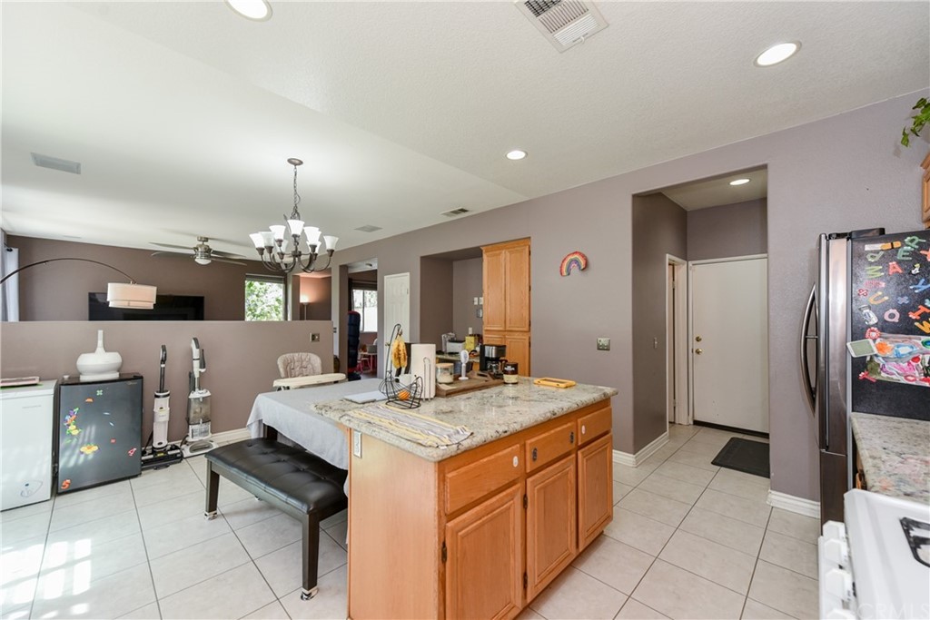 7637 Pinot Place Rancho Cucamonga, CA 91739 - Photo 13 of 39 a large kitchen with a counter space a sink appliances and cabinets