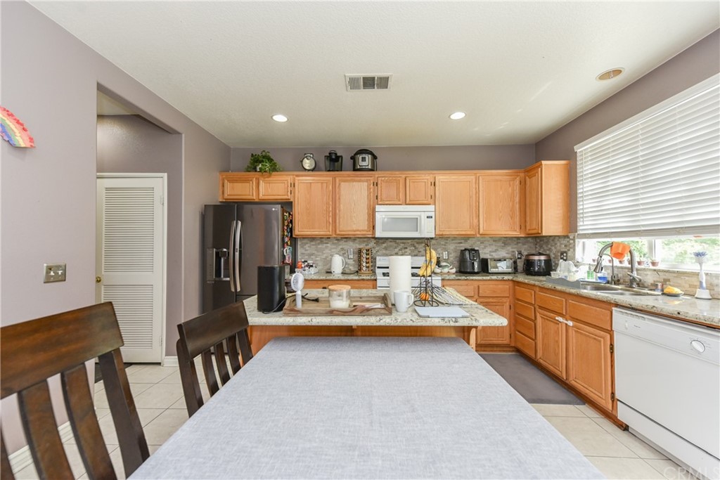 7637 Pinot Place Rancho Cucamonga, CA 91739 - Photo 15 of 39 a large kitchen with lots of counter space and refrigerator