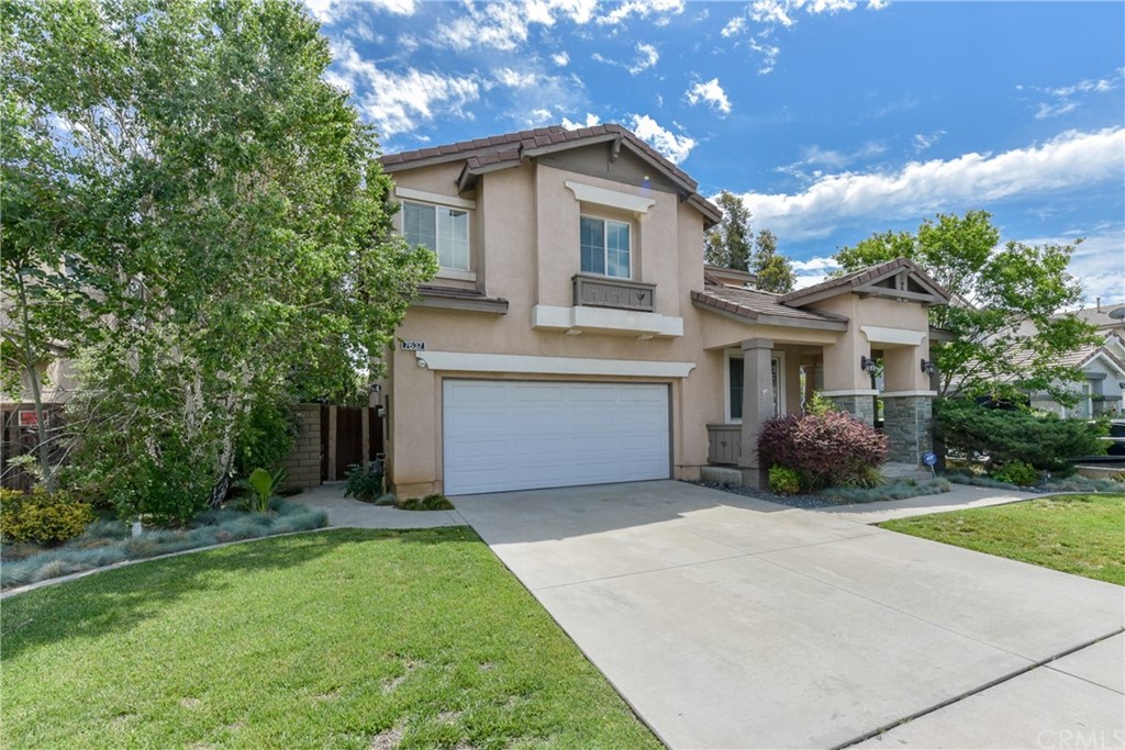 7637 Pinot Place Rancho Cucamonga, CA 91739 - Photo 2 of 39 a front view of a house with a garden and garage
