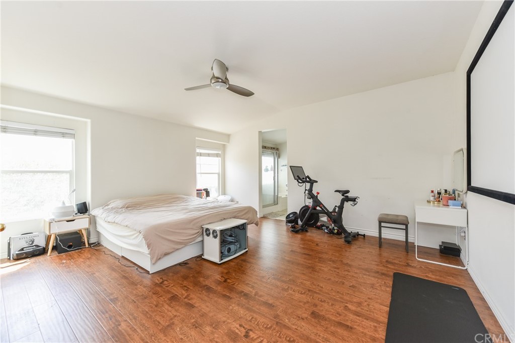 7637 Pinot Place Rancho Cucamonga, CA 91739 - Photo 21 of 39 a bedroom with a bed and a large window