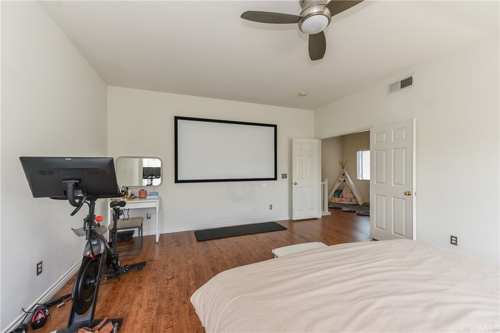 7637 Pinot Place Rancho Cucamonga, CA 91739 - Photo 22 of 39 a bedroom with a bed and wooden floor