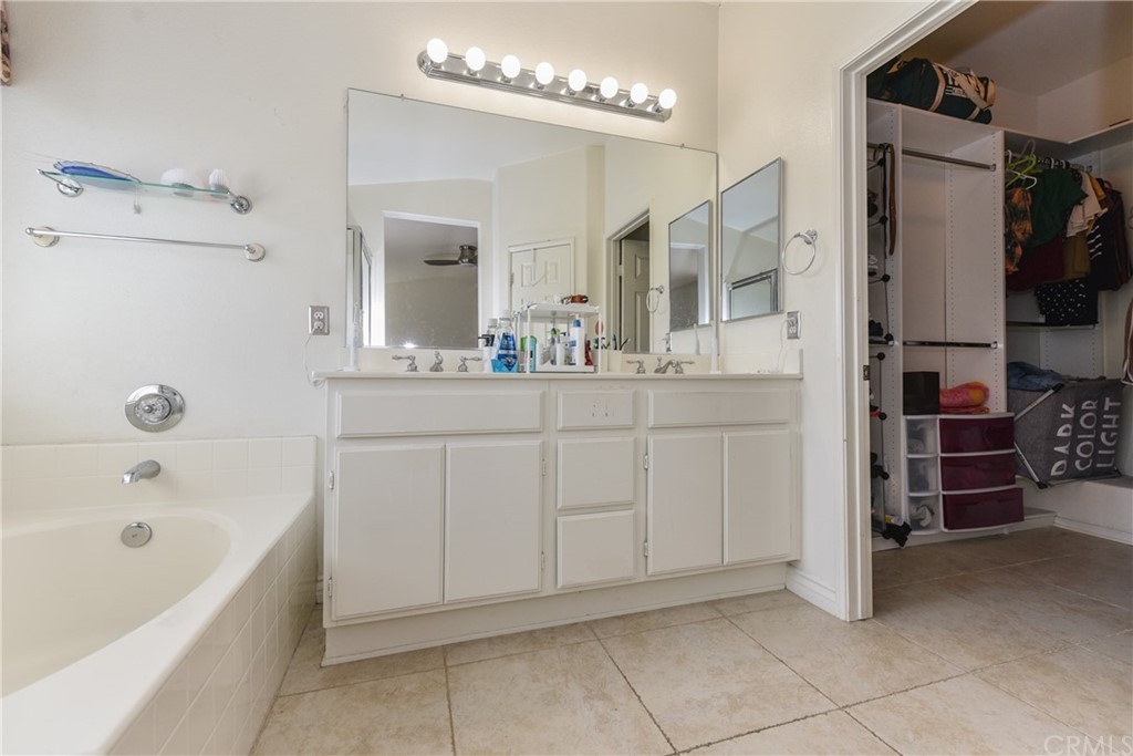 7637 Pinot Place Rancho Cucamonga, CA 91739 - Photo 23 of 39 a bathroom with a bathtub sink and mirror