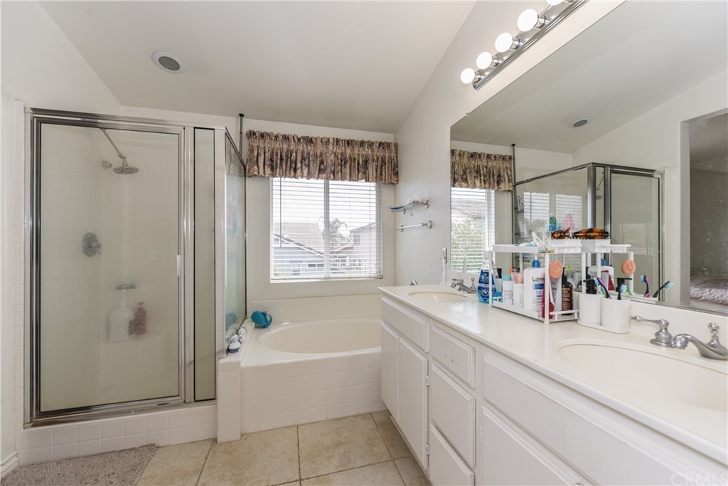7637 Pinot Place Rancho Cucamonga, CA 91739 - Photo 25 of 39 a bathroom with a tub a sink shower and mirror