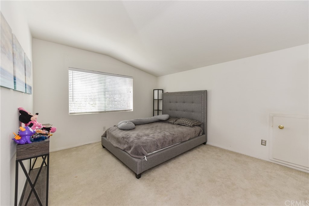 7637 Pinot Place Rancho Cucamonga, CA 91739 - Photo 30 of 39 a bedroom with a bed and a potted plant