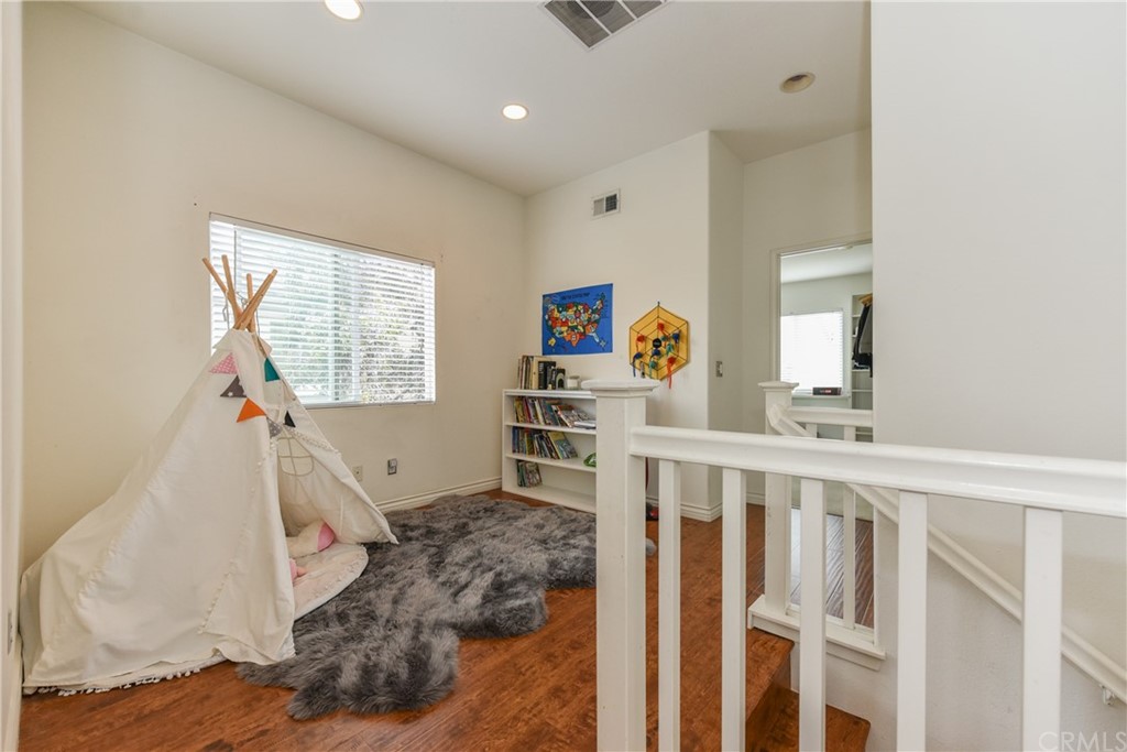 7637 Pinot Place Rancho Cucamonga, CA 91739 - Photo 32 of 39 a living room with wooden floor and a large window