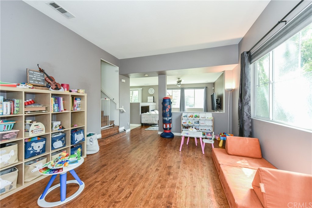 7637 Pinot Place Rancho Cucamonga, CA 91739 - Photo 4 of 39 a living room with furniture a rug and a large window
