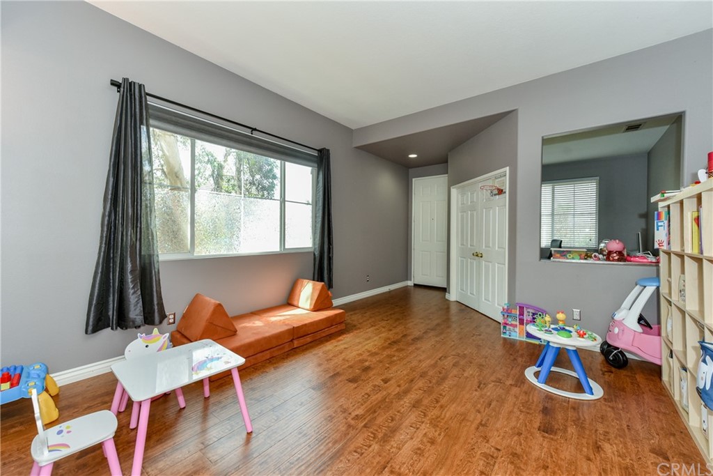 7637 Pinot Place Rancho Cucamonga, CA 91739 - Photo 6 of 39 a living room with dining room and wooden floor