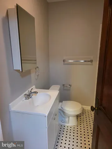 a bathroom with a sink a toilet and a mirror