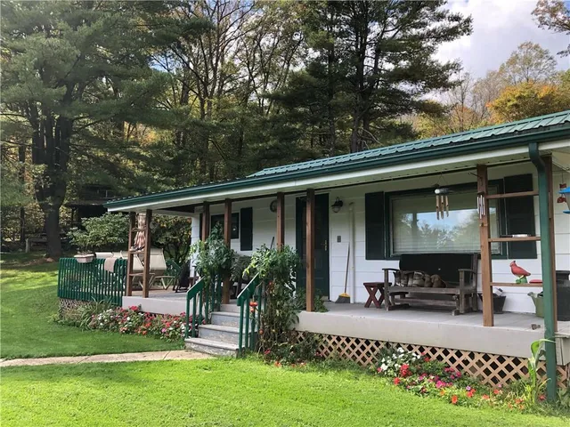 a view of house and yard with swimming pool