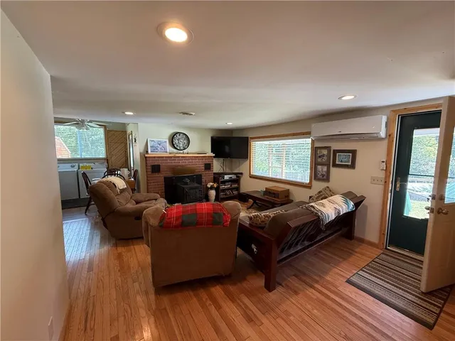 a living room with furniture a fireplace and a wooden floor