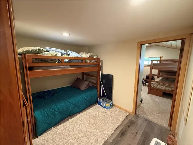 a bedroom with a bed and a ceiling fan