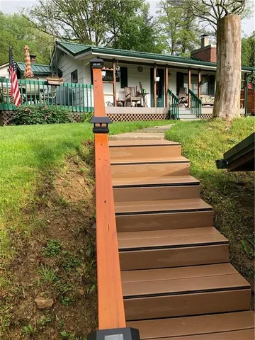 a front view of a house with a yard table and chairs