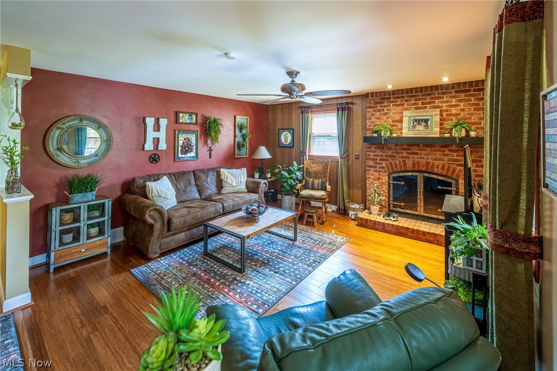1825 Dexter Road Northeast Massillon, OH 44646 - Photo 4 of 30 Living room with an all-brick, wood burning fireplace, custom glass doors, and curved hearth.