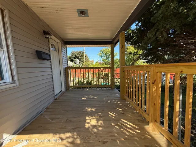 a view of a porch with wooden floor