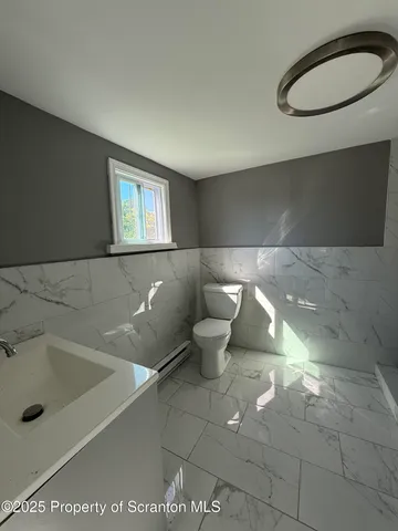 a bathroom with a toilet and a sink