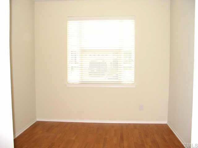 8206 Stone Cellar Drive Raleigh, NC 27613 - Photo 3 of 10 a view of a small space with wooden floor and a window