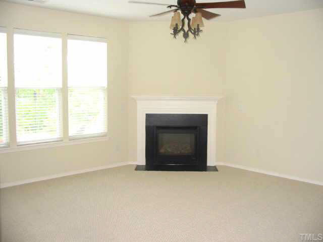 8206 Stone Cellar Drive Raleigh, NC 27613 - Photo 4 of 10 a view of empty room with a fireplace