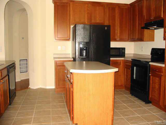8206 Stone Cellar Drive Raleigh, NC 27613 - Photo 5 of 10 a kitchen with a refrigerator and a stove
