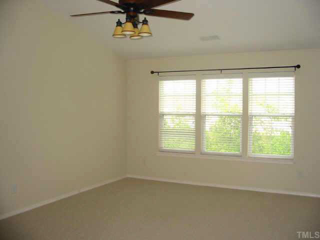 8206 Stone Cellar Drive Raleigh, NC 27613 - Photo 7 of 10 an empty room with a window
