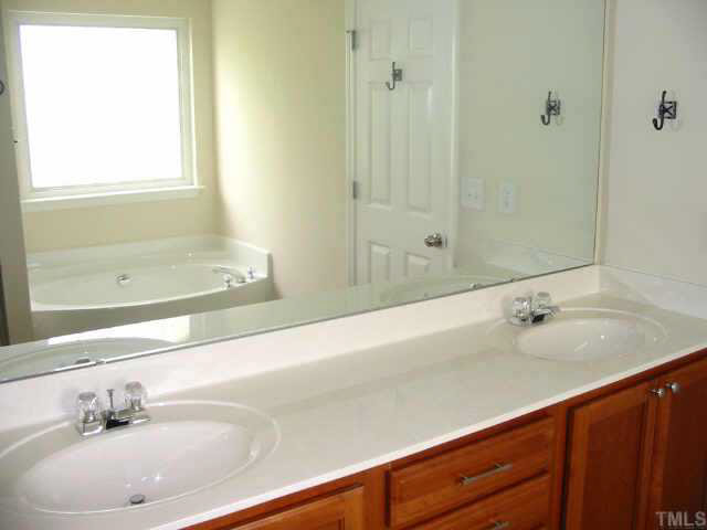 8206 Stone Cellar Drive Raleigh, NC 27613 - Photo 8 of 10 a bathroom with a bathtub and a sink