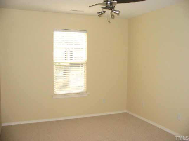 8206 Stone Cellar Drive Raleigh, NC 27613 - Photo 9 of 10 an empty room with a window