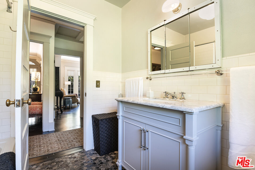 1918 Pinehurst Road Los Angeles, CA 90068 - Photo 31 of 66 a bathroom with a granite countertop sink and a mirror