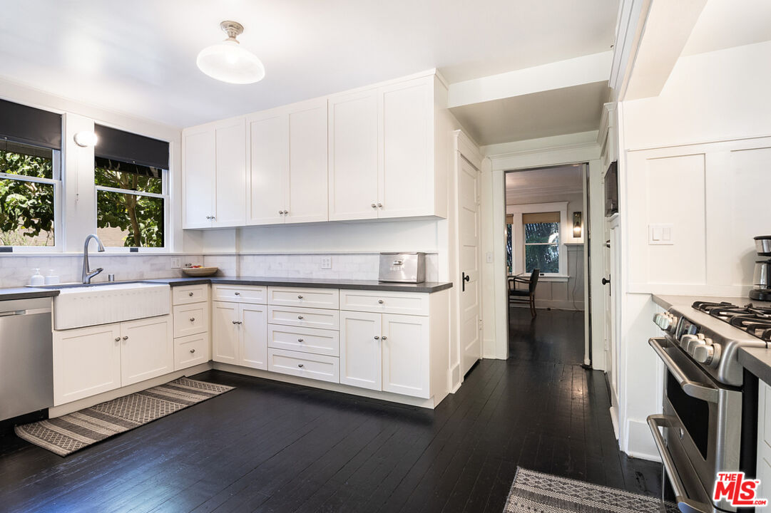 1918 Pinehurst Road Los Angeles, CA 90068 - Photo 38 of 66 a kitchen with granite countertop cabinets stainless steel appliances and a window