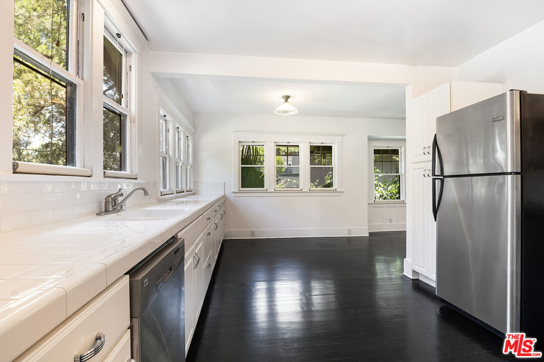 1918 Pinehurst Road Los Angeles, CA 90068 - Photo 55 of 66 a kitchen with a refrigerator a sink and a window