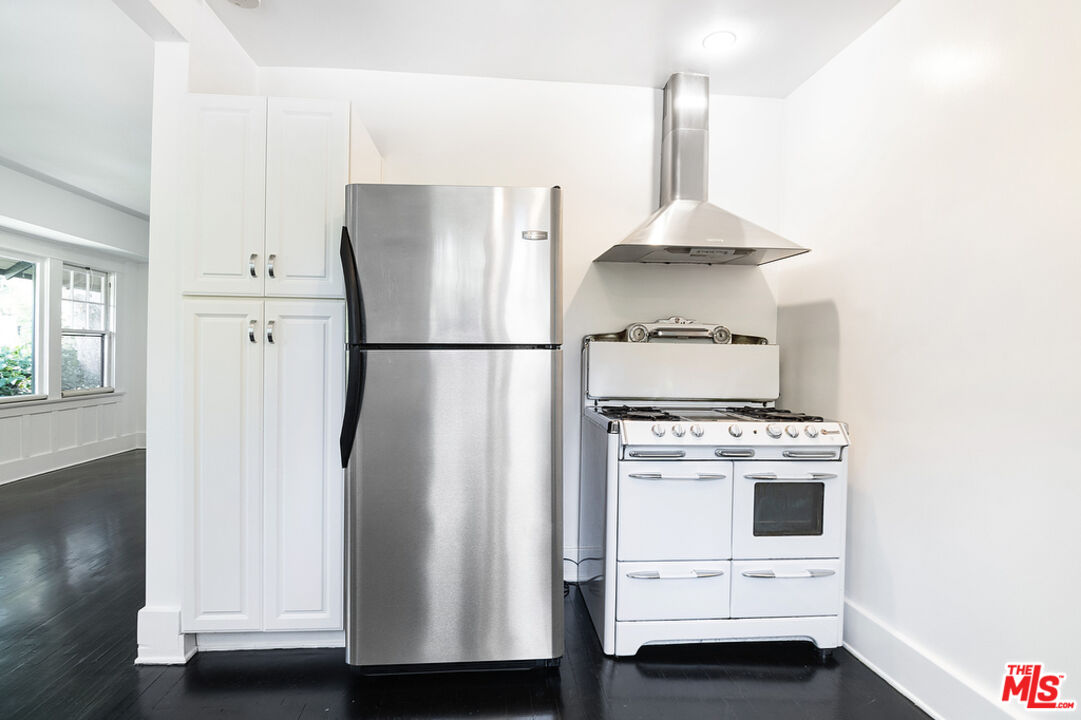 1918 Pinehurst Road Los Angeles, CA 90068 - Photo 56 of 66 a kitchen with a refrigerator a stove and white cabinets