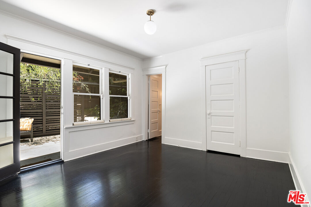 1918 Pinehurst Road Los Angeles, CA 90068 - Photo 57 of 66 an empty room with wooden floor and windows