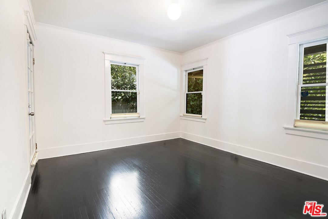 1918 Pinehurst Road Los Angeles, CA 90068 - Photo 60 of 66 a view of an empty room with wooden floor and a window