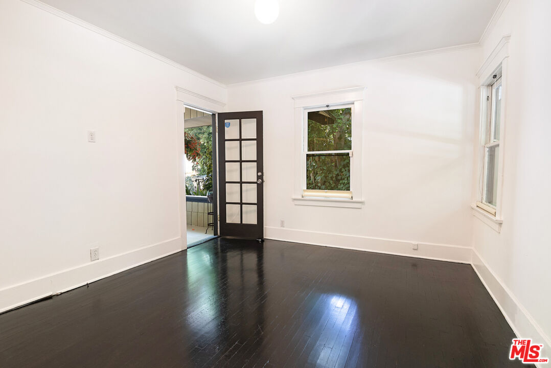 1918 Pinehurst Road Los Angeles, CA 90068 - Photo 61 of 66 an empty room with wooden floor and windows