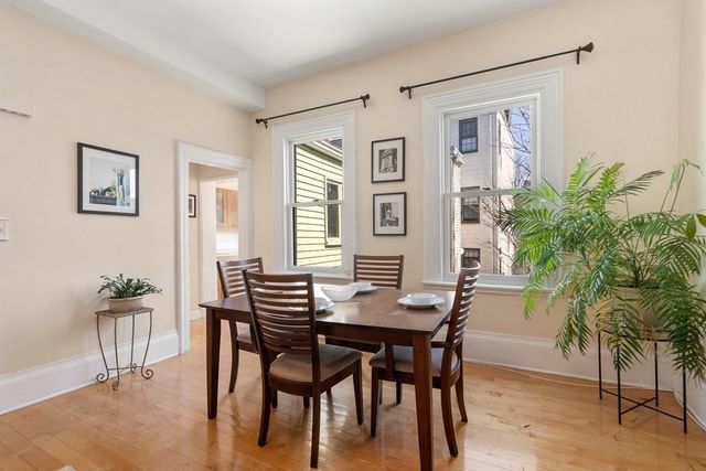 a view of a dining room with furniture and a potted plant