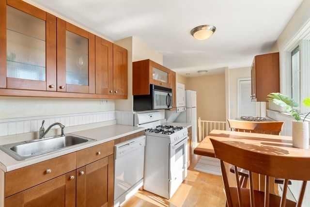 a kitchen with stainless steel appliances a sink stove and cabinets