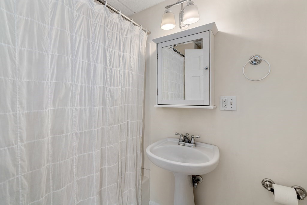 45 Baldwin Street, Unit 2 Boston, MA 02129 - Photo 7 of 12 a bathroom with a sink a mirror and vanity