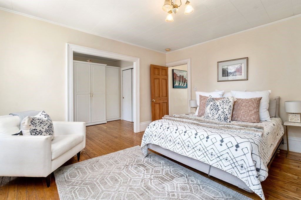 45 Baldwin Street, Unit 2 Boston, MA 02129 - Photo 10 of 12 a bedroom with a bed and a couch