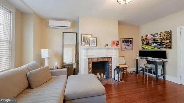 a living room with furniture and a fireplace