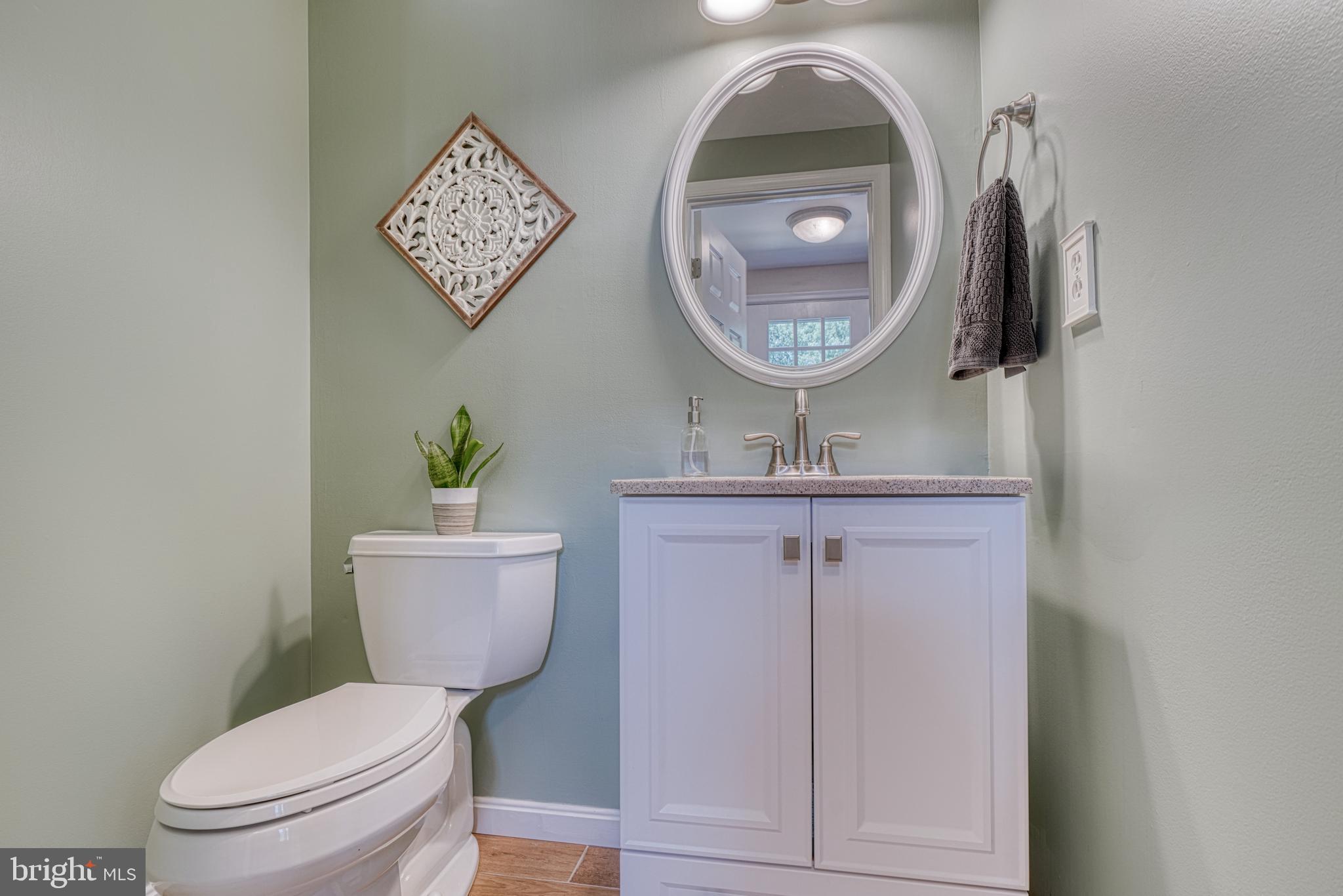 25 Ramsgate Court Halethorpe, MD 21227 - Photo 4 of 30 a bathroom with a toilet a sink and mirror